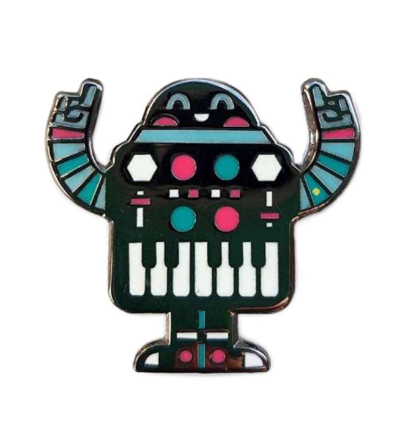 An enamel pin badge of a dancing black robot with a sweet smile and piano in his tummy.