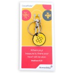 Custom trolley coin keyring with yellow enamel coin and black geometric cross design, attached to metal clasp and ring, displayed on CauseFinder backing card with Matthew 6:21 stewardship message.