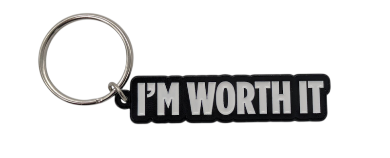 A black and white soft enamel keyring that says 
