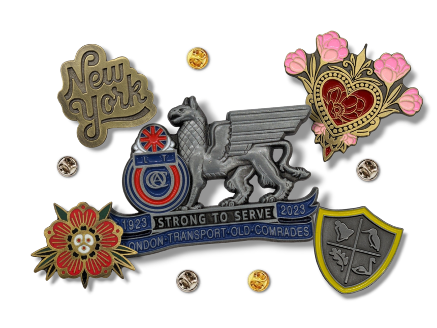 A collection of vintage-looking pin badges in various platings and antique finishes.