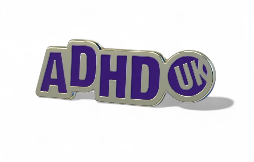 an ADHD UK awareness pin pin badge with silver plating and purple enamel.