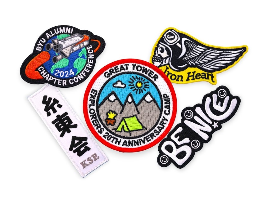 Collection of custom embroidered patches with bold colours and logos showing typical styles used for branding and identity.