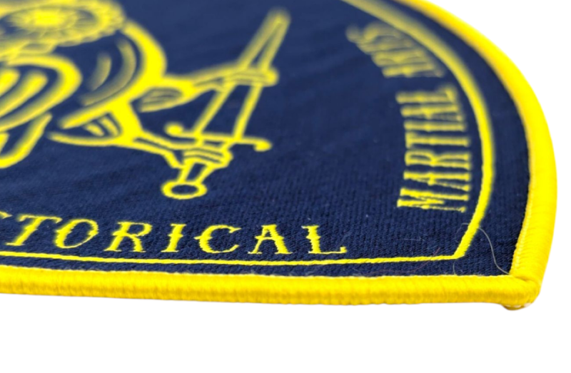 A close-up of the edge of a blue and yellow patch with a yellow border.