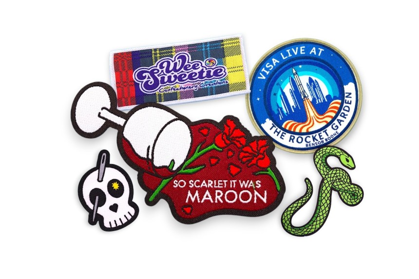 Collection of custom woven patches showing detailed logos, floral branding, event badges, and colourful fine thread designs.