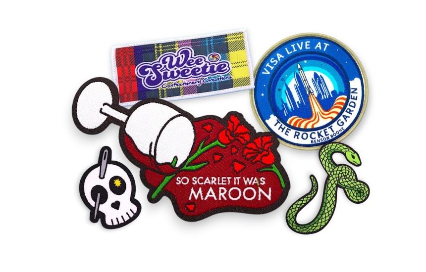 Collection of custom woven patches showing detailed logos, floral branding, event badges, and colourful fine thread designs.