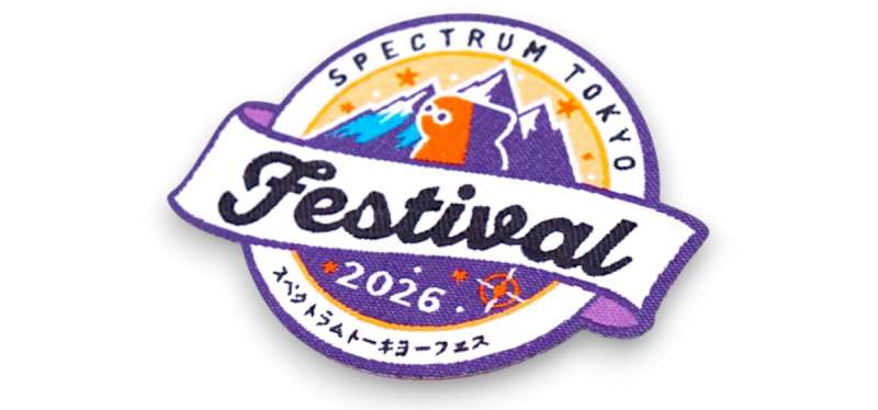 Detailed custom woven festival badge with small text, layered colours, and sharp linework showing precision thread detail.