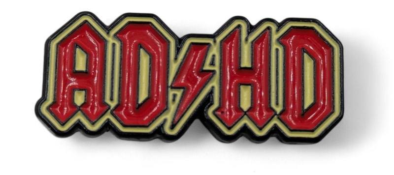 A red and yellow pin badge that says ADHD in the style of the ACDC logo.
