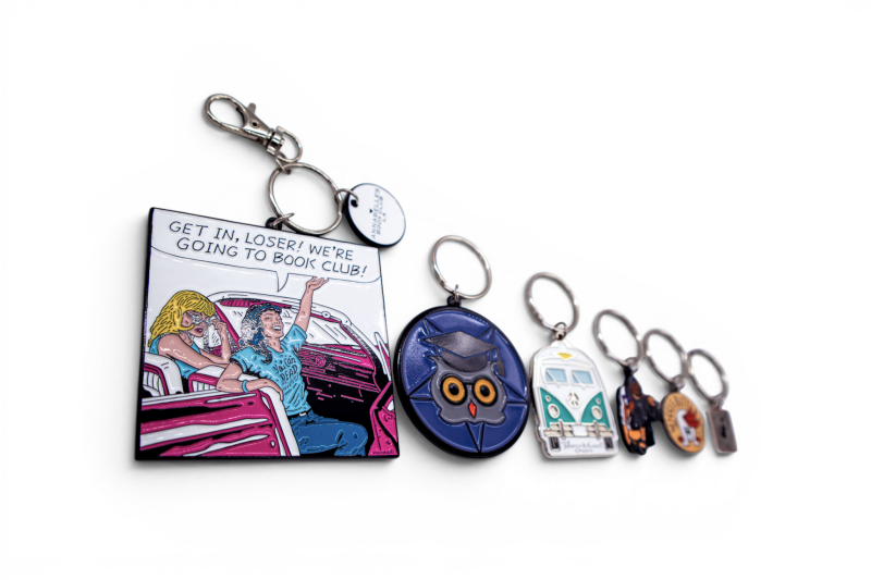 Custom enamel keyrings arranged from large to small, showing how different keyring sizes compare when placed side by side.