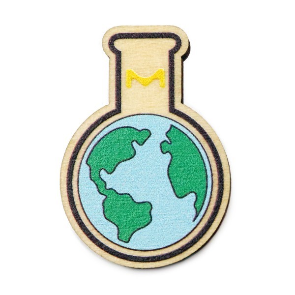 A sustainable eco-friendly wooden pin badge that features the world inside a test tube.
