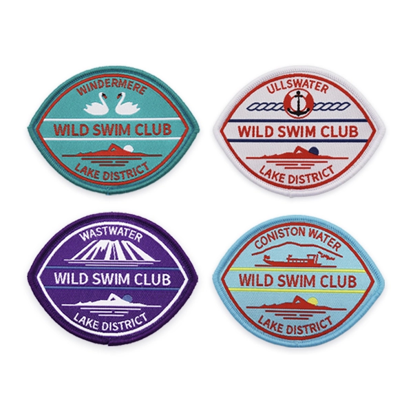 Collection of oval woven patches for Lake District wild swim clubs, featuring lake names, icons and landscapes, produced as custom woven patches UK for outdoor clubs, memberships and branded swimwear.