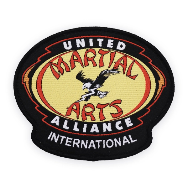 Oval woven patch with United Martial Arts Alliance International text and eagle graphic, stitched in bold colours, designed as a custom woven patch for martial arts organisations and uniforms.