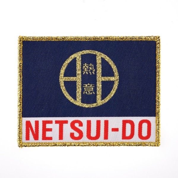 A rectangular patch with blue and white background and golden threads around the edge. The text reads