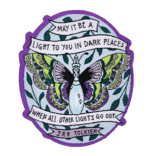A custom woven patch featuring a beautiful purple butterfly and a quote from a book.
