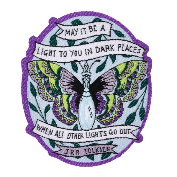 A custom woven patch featuring a beautiful purple butterfly and a quote from a book.