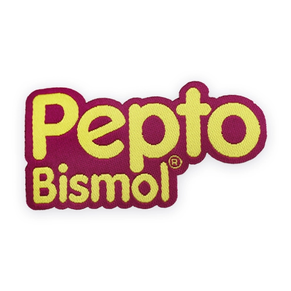 Bright woven patch displaying the Pepto Bismol logo in pink and yellow thread, produced as a clean custom woven patch ideal for promotional use, novelty items or brand inspired woven patches.